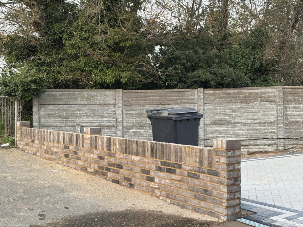 Low brick wall installation for bin storage area – residential landscaping Essex
